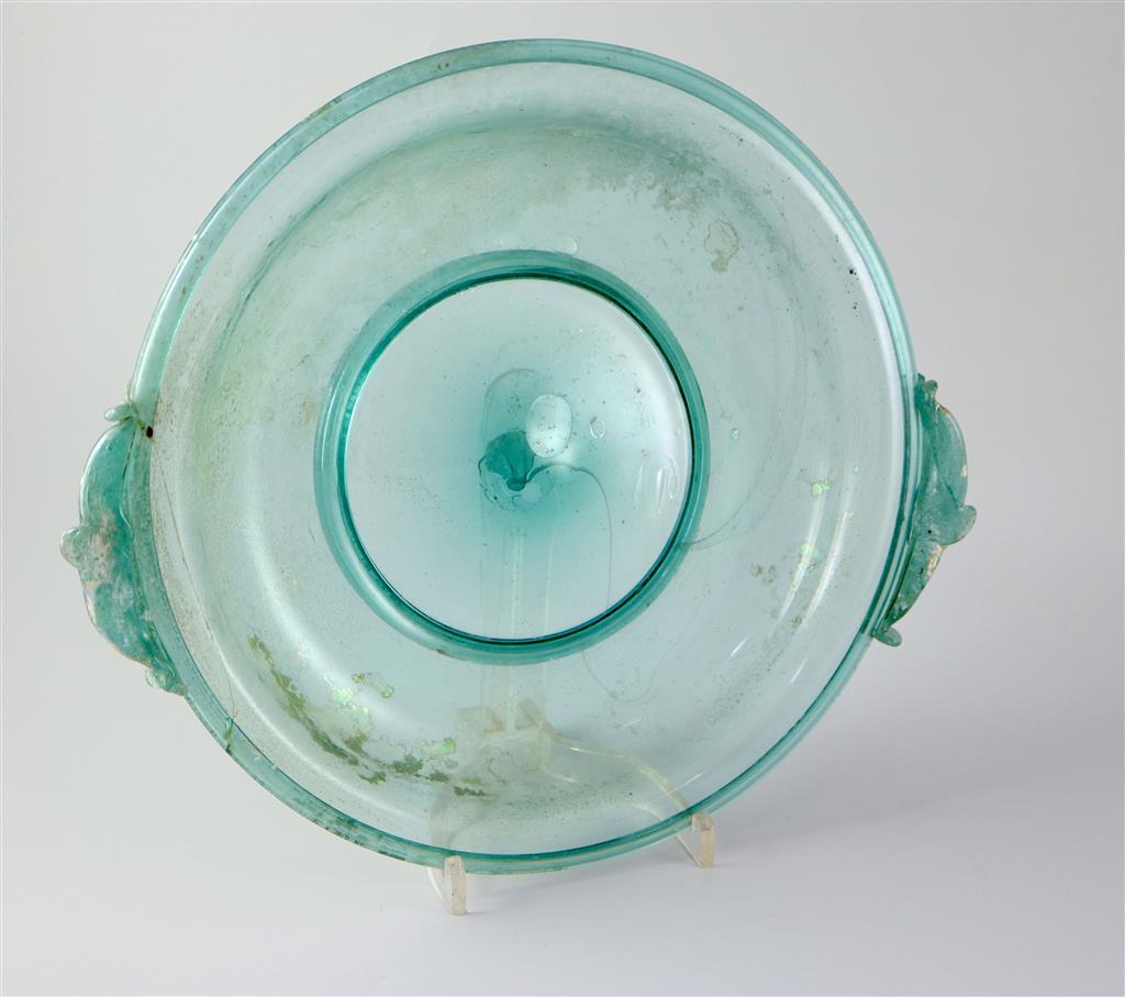 A Roman green glass dish, 1st/2nd century AD, 33cm across